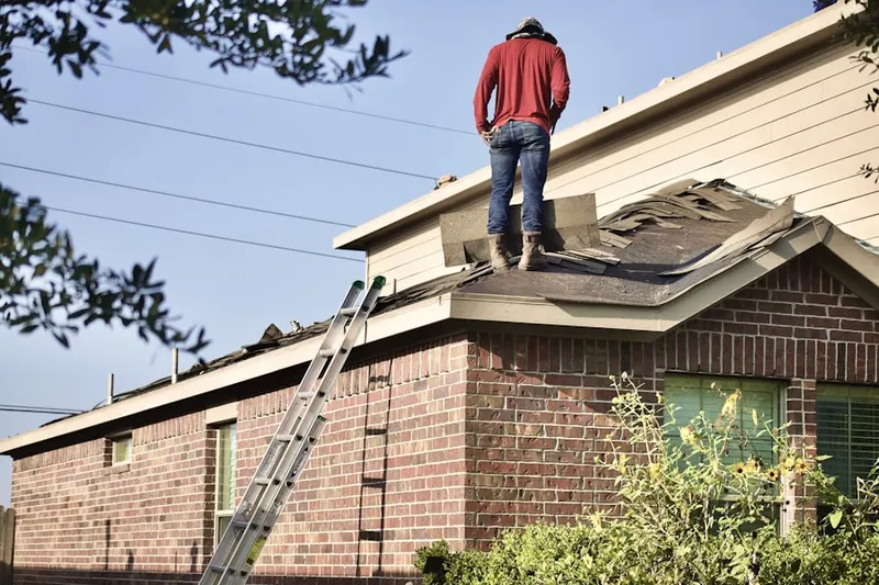 Professional roofer working on a residential roof in San Martin